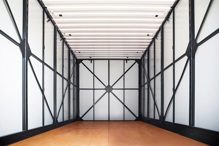 A large white room with black trim and wooden floors.