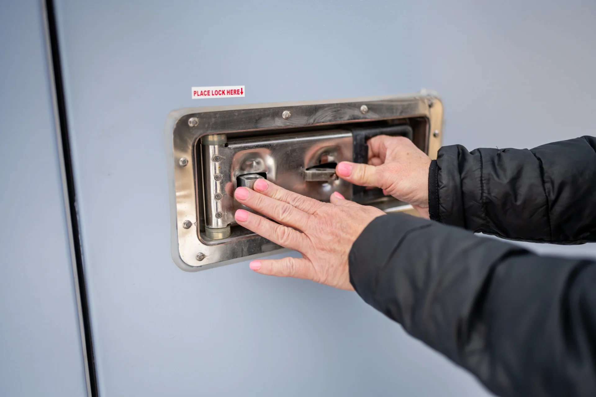 A person opening the door of a room.