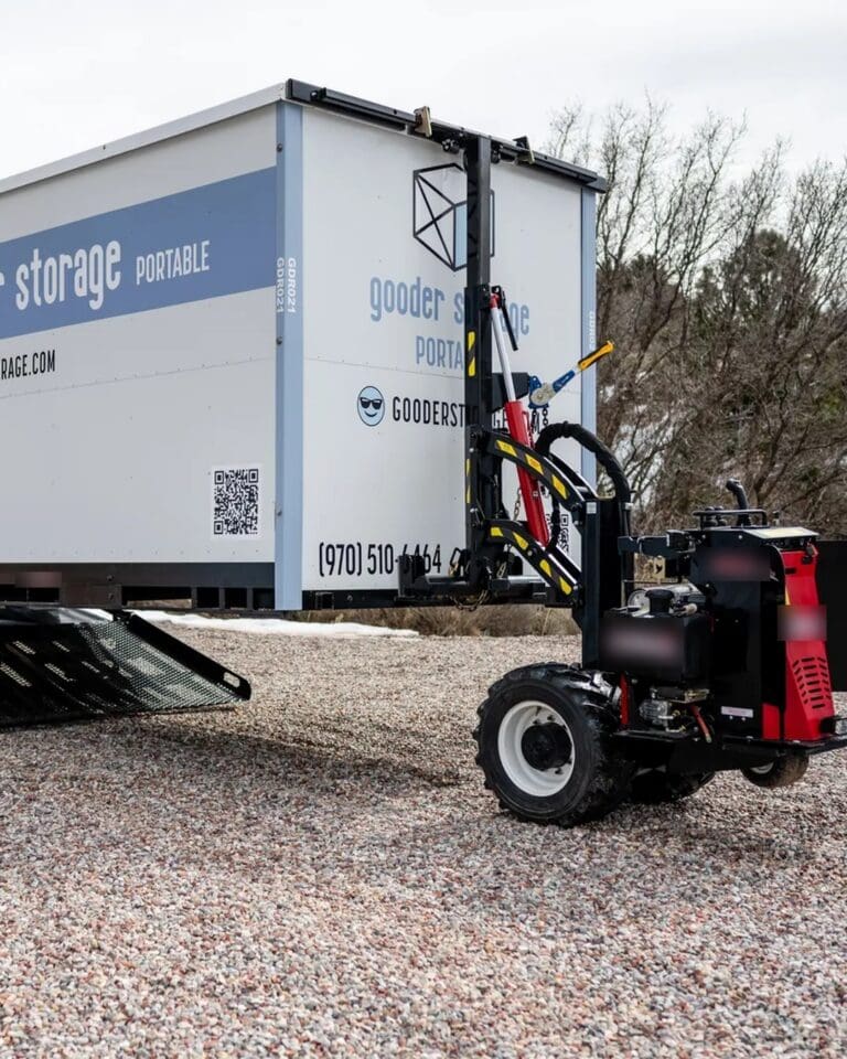 Remote-controlled delivery bot setting a Gooder Box down level on a gravel pad